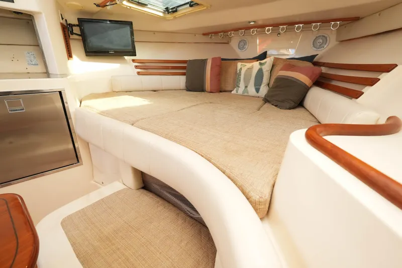 Slide: The Image of Luxurious interior of 2003 Grady-White Express 330 boat with cozy seating and TV. - 22