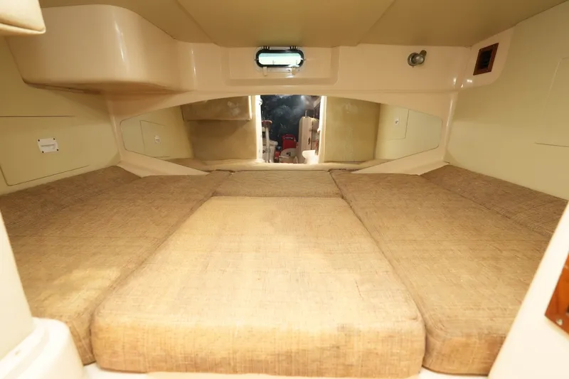 Slide: The Image of 2003 Grady-White Express 330 cabin interior with beige cushions and compact design. - 24