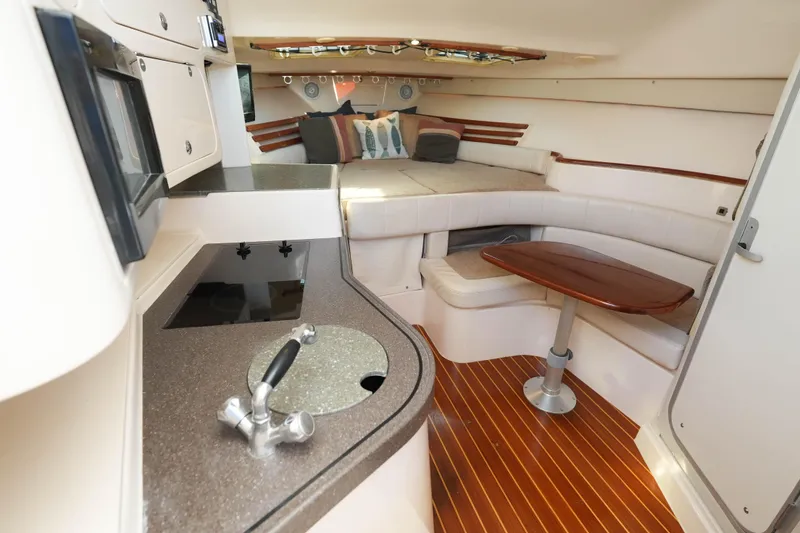 Slide: The Image of Luxurious interior of 2003 Grady-White Express 330 boat with cozy seating and TV. - 25