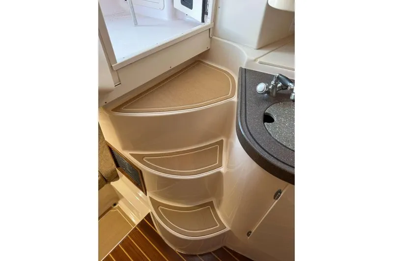 Slide: The Image of 2003 Grady-White Express 330 interior with sink and storage compartments. - 28