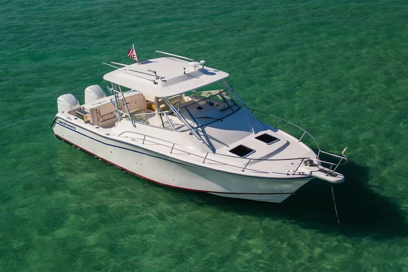 Slide: The Image of 2003 Grady-White Express 330 boat anchored in clear turquoise water. - 3