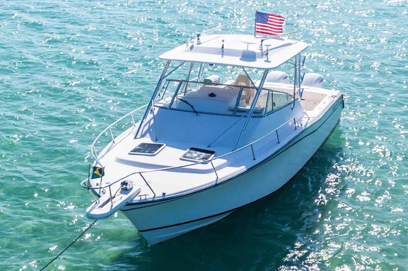 Slide: The Image of 2003 Grady-White Express 330 boat on sparkling turquoise water with American flag. - 5