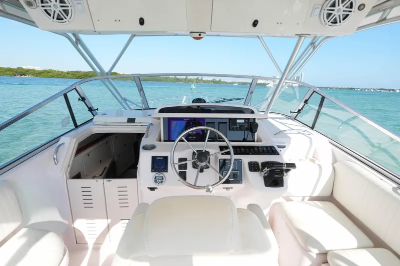 Slide: The Image of 2003 Grady-White Express 330 boat cockpit with steering wheel and navigation equipment. - 7