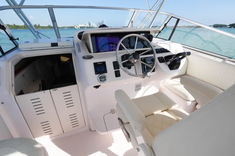 Slide: The Image of 2003 Grady-White Express 330 helm with steering wheel and navigation equipment. - 9