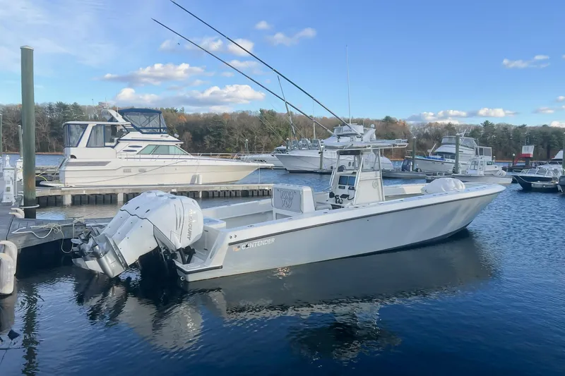 The Image of 2002 Contender 36 Open boat docked at marina with clear blue sky. - 1