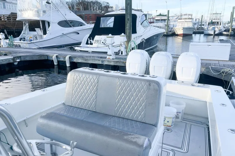 Slide: The Image of 2002 Contender 36 Open boat at marina with luxury seating and multiple outboard engines. - 11