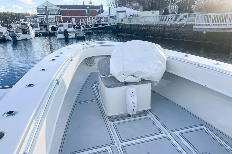 Slide: The Image of 2002 Contender 36 Open boat docked at marina, featuring spacious deck and seating. - 12