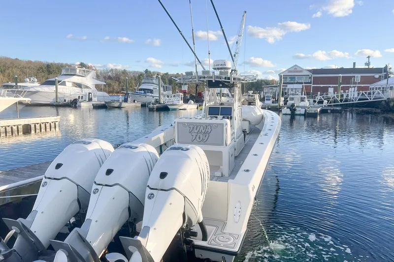 Slide: The Image of 2002 Contender 36 Open boat docked with triple outboard engines. - 13