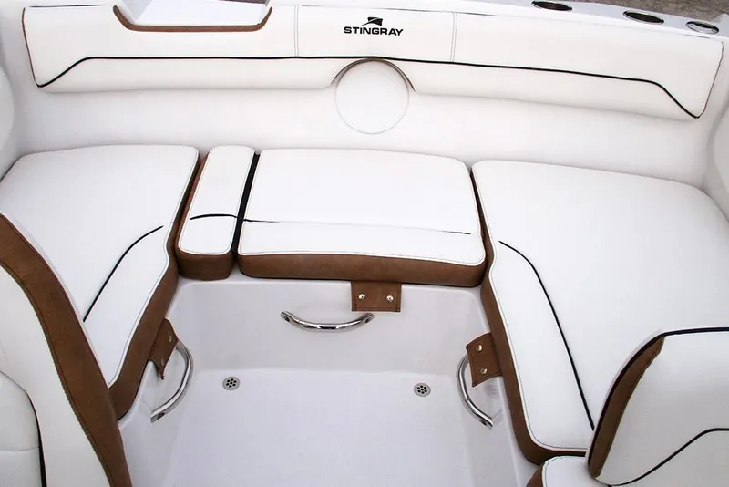 Slide: The Image of 2026 Stingray 172 DC boat interior with white and brown cushioned seating. - 17
