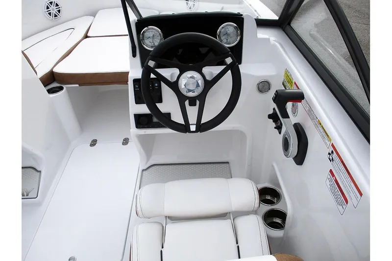 Slide: The Image of 2026 Stingray 172 DC boat cockpit with steering wheel and white seating. - 23