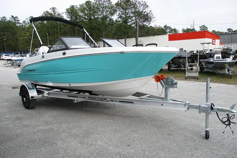 Slide: The Image of 2026 Stingray 172 DC boat on trailer, turquoise hull, parked outdoors. - 5