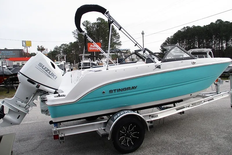 Slide: The Image of 2026 Stingray 172 DC boat with Suzuki outboard motor on a trailer. - 6