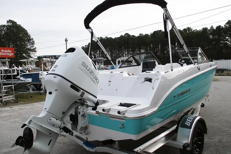 Slide: The Image of 2026 Stingray 172 DC boat with Suzuki outboard motor, parked outdoors. - 7