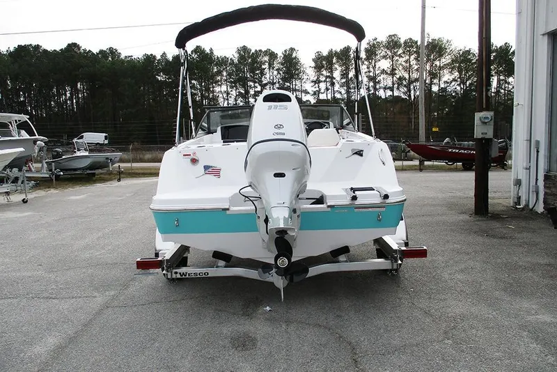 Slide: The Image of 2026 Stingray 172 DC boat with outboard motor on trailer, parked outdoors. - 8