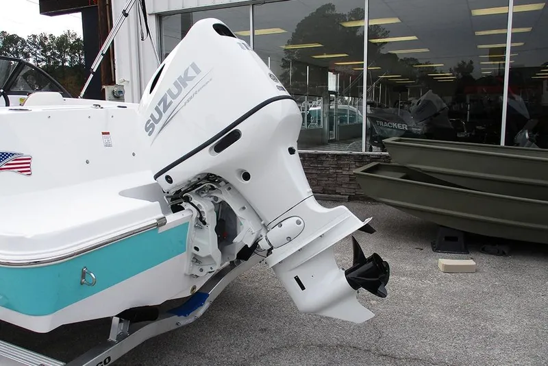 Slide: The Image of 2026 Stingray 172 DC boat with Suzuki outboard motor, displayed outside a showroom. - 9