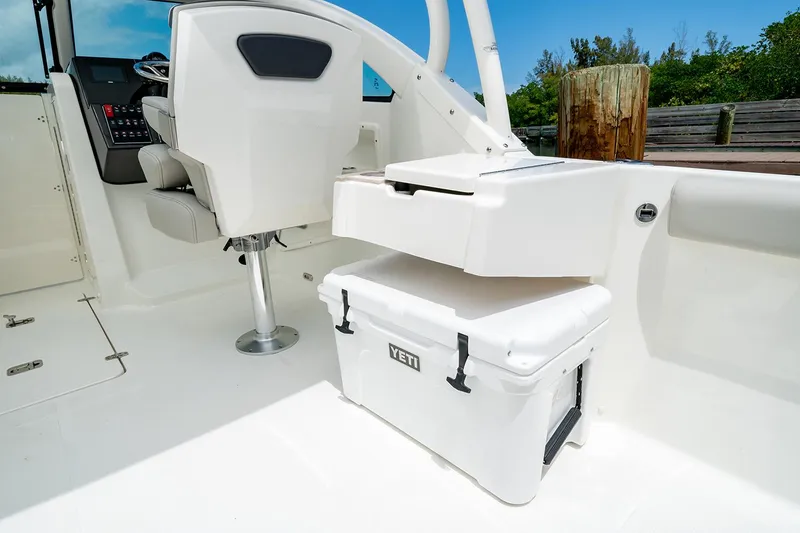Slide: The Image of Manufacturer Provided Image: 2025 Pursuit DC 246 Dual Console boat interior with compact marine toilet. - 14