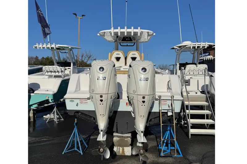 Slide: The Image of 2024 Sportsman Open 262 Center Console with twin outboard engines. - 3