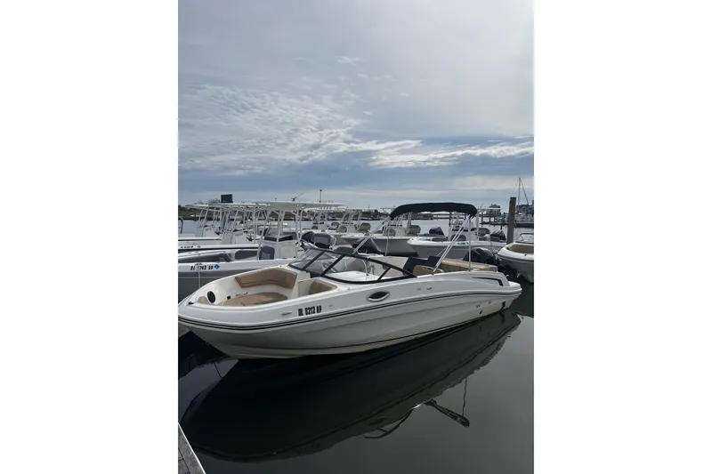 The Image of 2025 Bayliner VR6 Bowrider OB docked at marina under cloudy sky. - 1