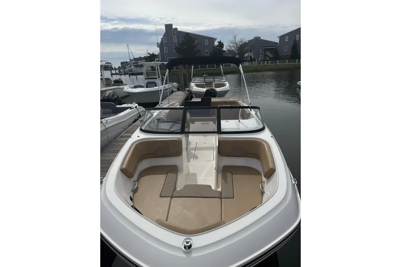 Slide: The Image of 2025 Bayliner VR6 Bowrider OB docked, showcasing spacious seating and sleek design. - 3