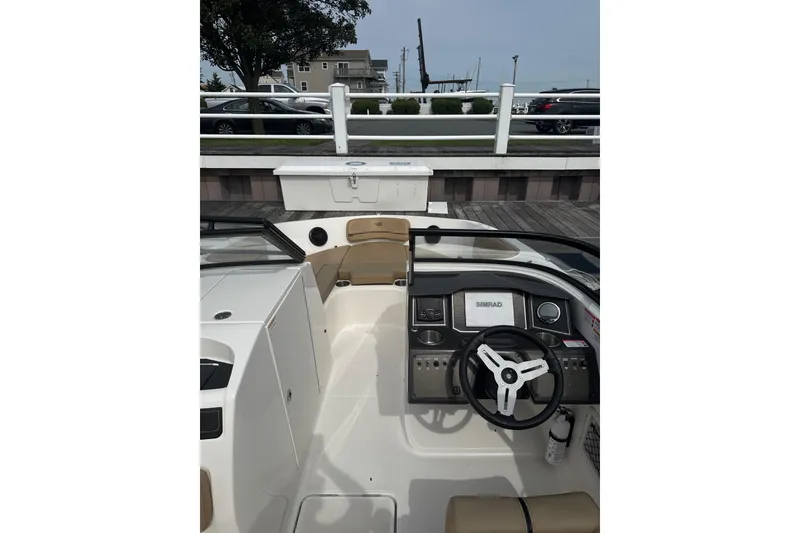 Slide: The Image of 2025 Bayliner VR6 Bowrider OB cockpit with steering wheel and dashboard controls. - 4