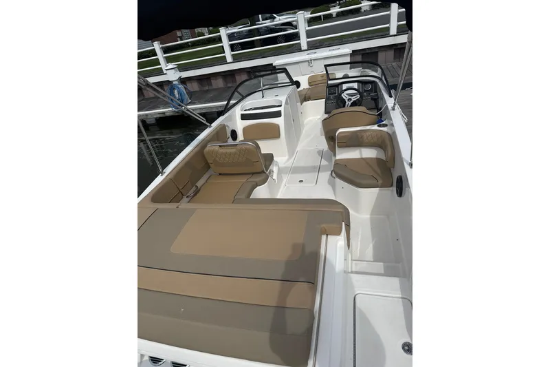 Slide: The Image of 2025 Bayliner VR6 Bowrider OB with tan seating, docked at marina. - 6