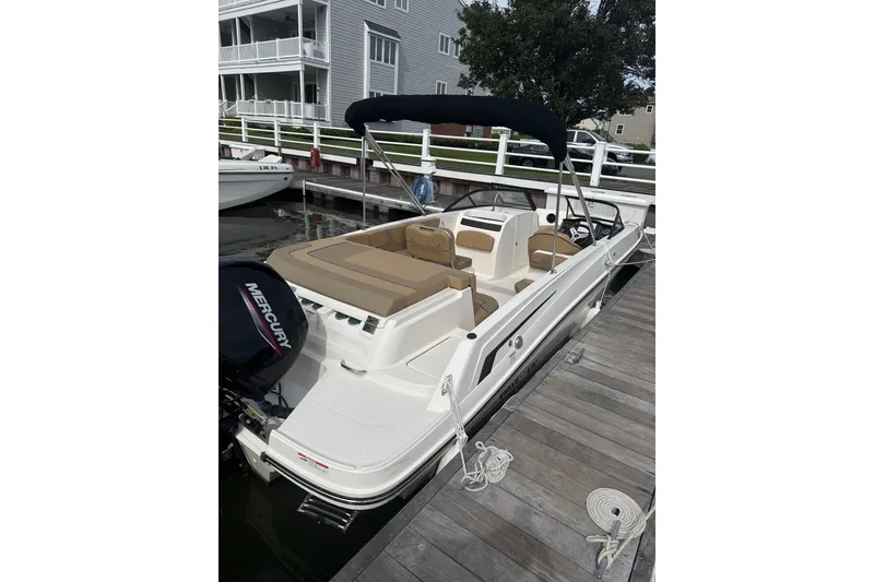 Slide: The Image of 2025 Bayliner VR6 Bowrider OB docked, featuring spacious seating and Mercury outboard engine. - 8