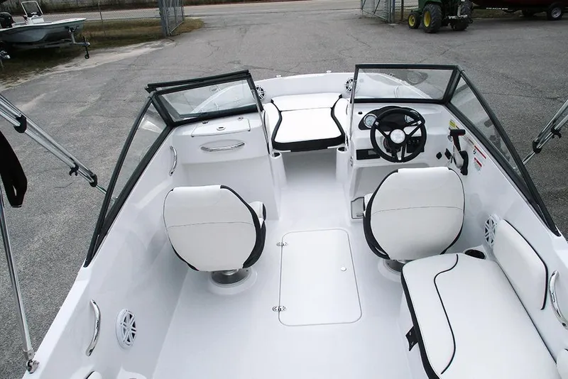 Slide: The Image of 2026 Stingray 191 DC boat interior with white seating and steering wheel. - 10
