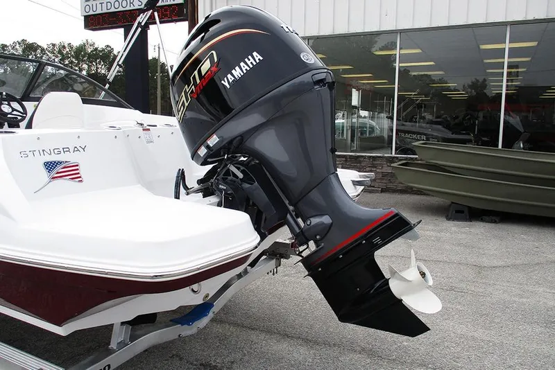 Slide: The Image of 2026 Stingray 191 DC boat with Yamaha outboard motor displayed outdoors. - 9