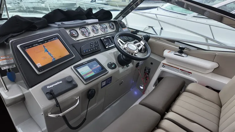 Slide: The Image of 2016 Sea Ray Sundancer 370 cockpit with modern navigation equipment. - 17