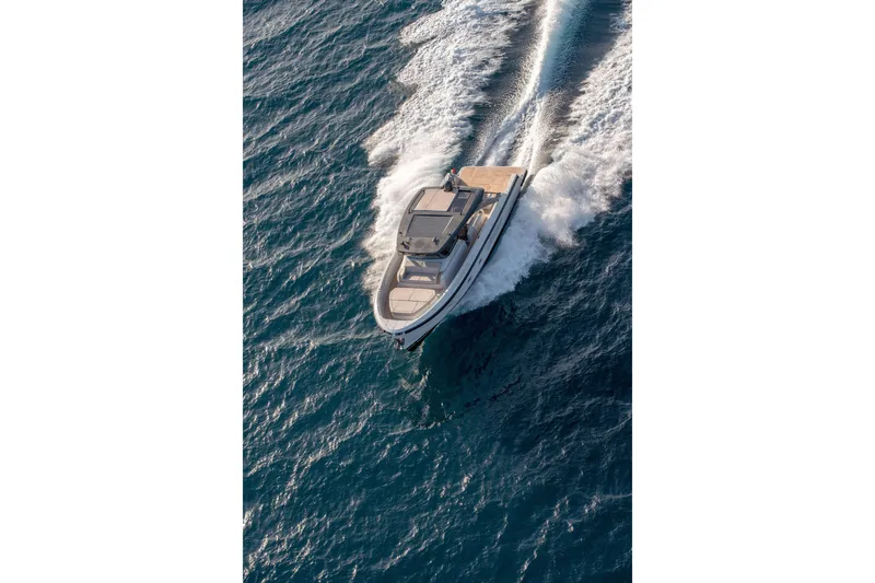 Slide: The Image of 2025 Bluegame BG54 yacht cruising on open water, aerial view. - 16