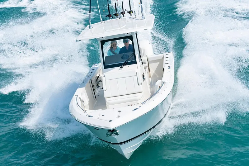 Slide: The Image of 2026 Pursuit S 268 Sport boat dashboard with steering wheel and control panel. - 5