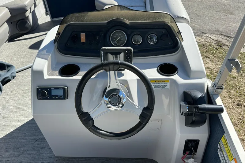 Slide: The Image of Steering console of 2022 Sweetwater 2086 CX boat with gauges and controls. - 10