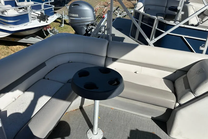 Slide: The Image of Interior of 2022 Sweetwater 2086 CX pontoon boat with seating and cup holder table. - 11