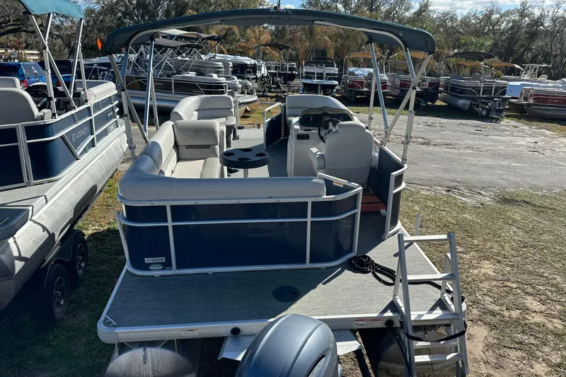 Slide: The Image of 2022 Sweetwater 2086 CX pontoon boat with canopy, parked on grass. - 12