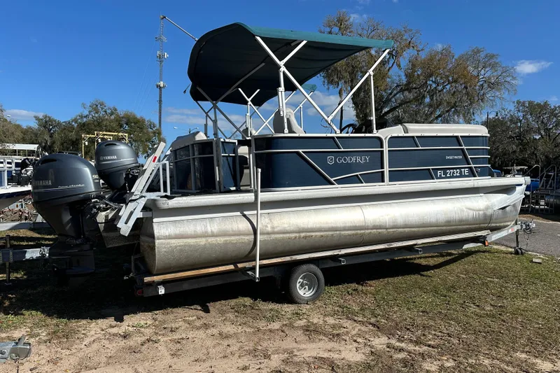Slide: The Image of 2022 Sweetwater 2086 CX pontoon boat on trailer, featuring Yamaha outboard motors. - 13