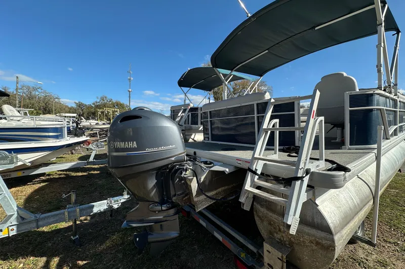 Slide: The Image of 2022 Sweetwater 2086 CX pontoon boat with Yamaha outboard motor, docked outdoors. - 14