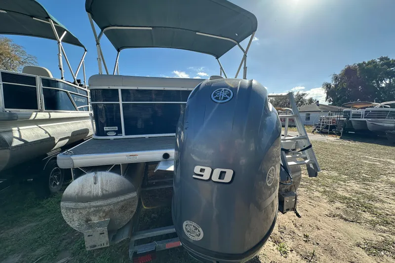 Slide: The Image of 2022 Sweetwater 2086 CX pontoon boat with Yamaha 90 outboard motor, parked outdoors. - 16