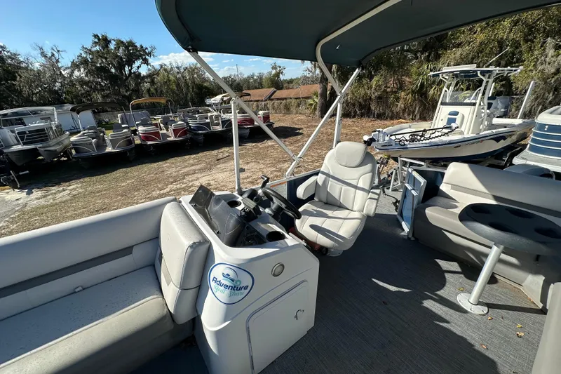 Slide: The Image of 2022 Sweetwater 2086 CX pontoon boat interior with helm and seating area. - 9