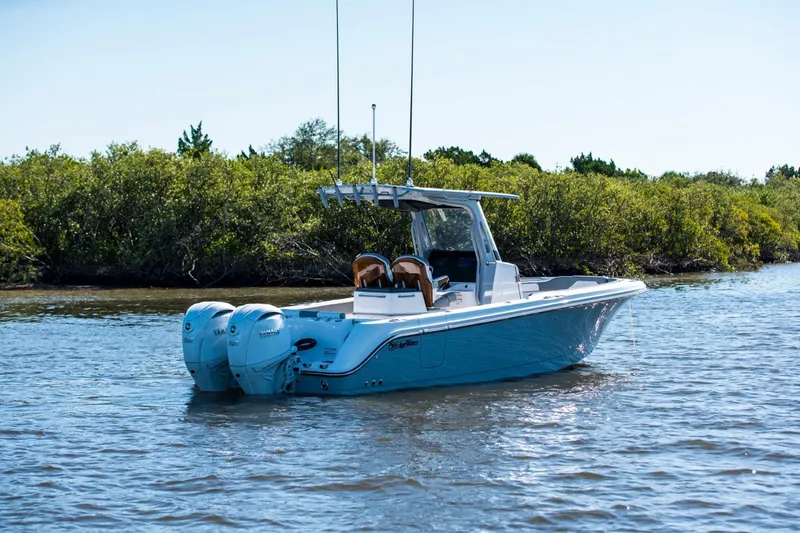 The Image of 2026 Edgewater 262CC boat with dual Yamaha engines on a calm waterway. - 0