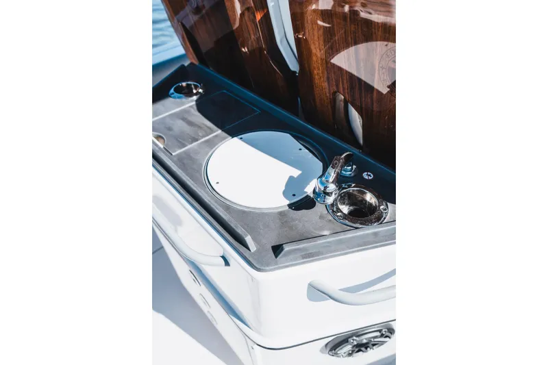 Slide: The Image of 2026 Edgewater 262CC boat sink and faucet detail with wooden accents. - 10