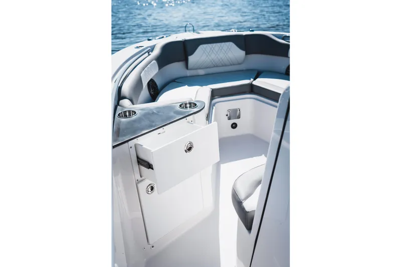 Slide: The Image of 2026 Edgewater 262CC boat interior with seating and storage, on a sunny day at sea. - 16