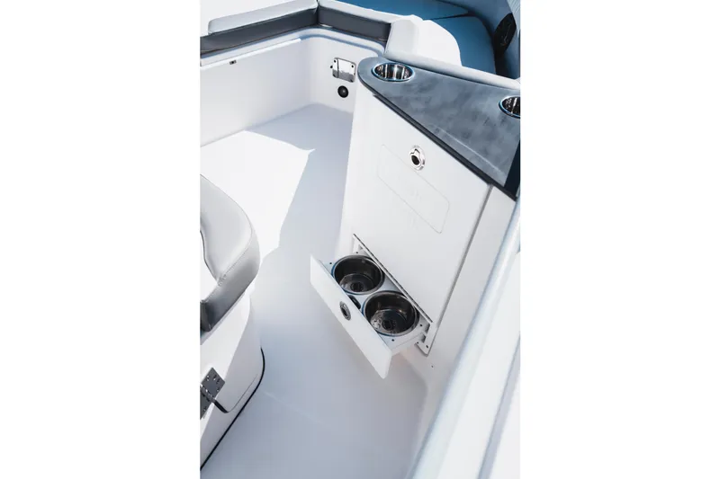 Slide: The Image of 2026 Edgewater 262CC boat interior with cup holders and seating area. - 18