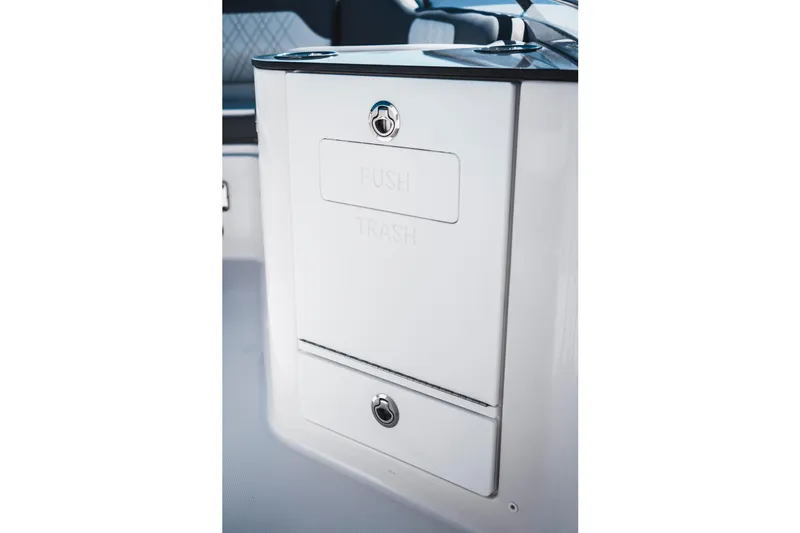 Slide: The Image of 2026 Edgewater 262CC boat interior with built-in trash compartment. - 19