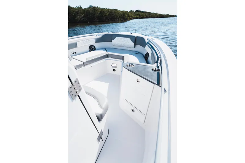 Slide: The Image of 2026 Edgewater 262CC boat interior with sleek seating and storage, on calm water. - 21