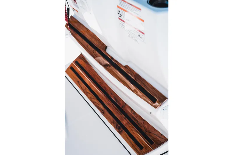 Slide: The Image of 2026 Edgewater 262CC boat with sleek wooden steps and modern design. - 23
