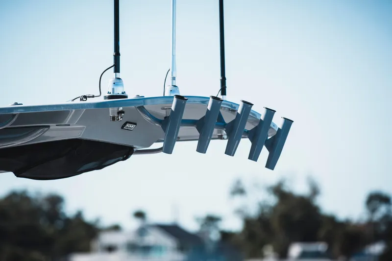 Slide: The Image of Close-up of 2026 Edgewater 262CC boat's rod holders and antennas against a blurred background. - 25