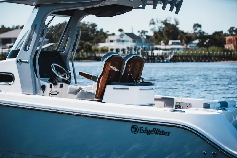 Slide: The Image of 2026 Edgewater 262CC boat on water, showcasing sleek design and modern features. - 5