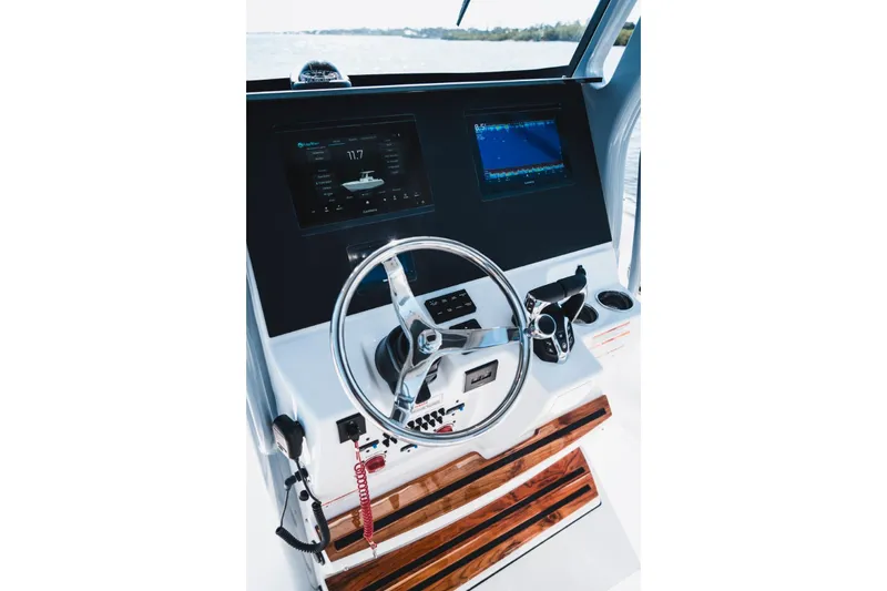 Slide: The Image of Helm of 2026 Edgewater 262CC boat with modern controls and navigation displays. - 7