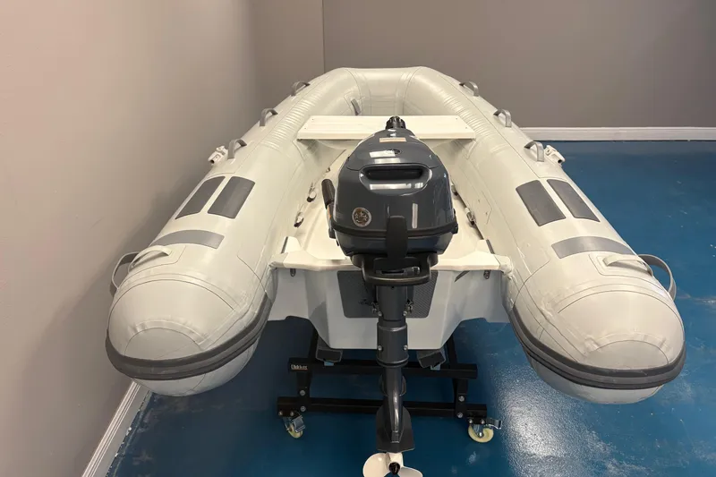 Slide: The Image of 2024 Caribe L-8 inflatable boat with Yamaha 4, sleek white design. - 6