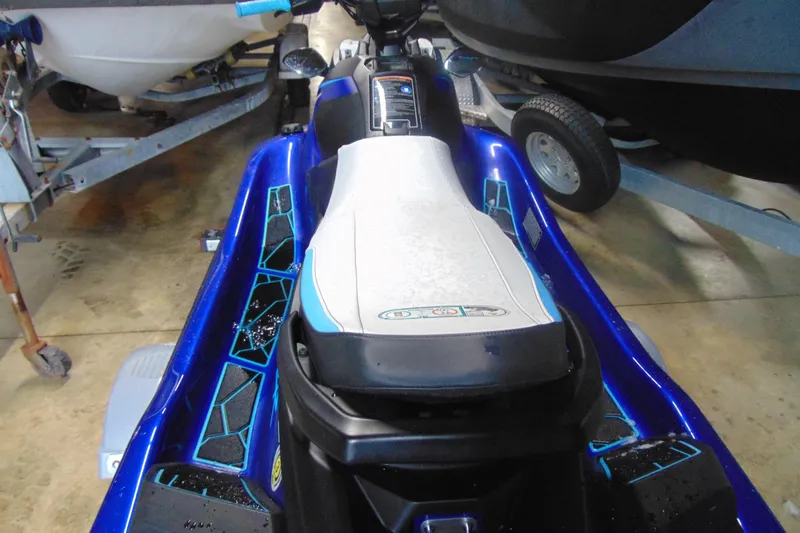 Slide: The Image of 2024 Yamaha WaveRunner JetBlaster in a showroom, showcasing sleek design and vibrant blue accents. - 3